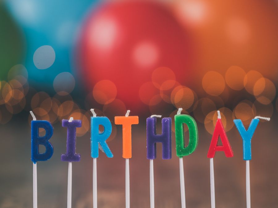 Birthday cake with lit candles at a celebration