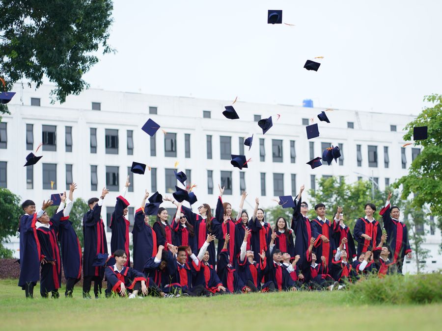 A graduate celebrating in cap and gown